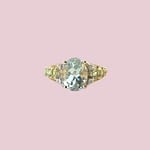 Gouden ring met groenblauwe edelsteen, peridoot en diamant